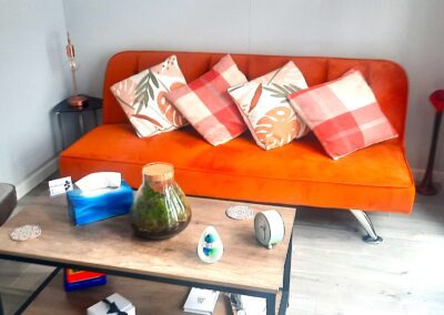 a large orange sofa in the clear-clarity counselling room in medway