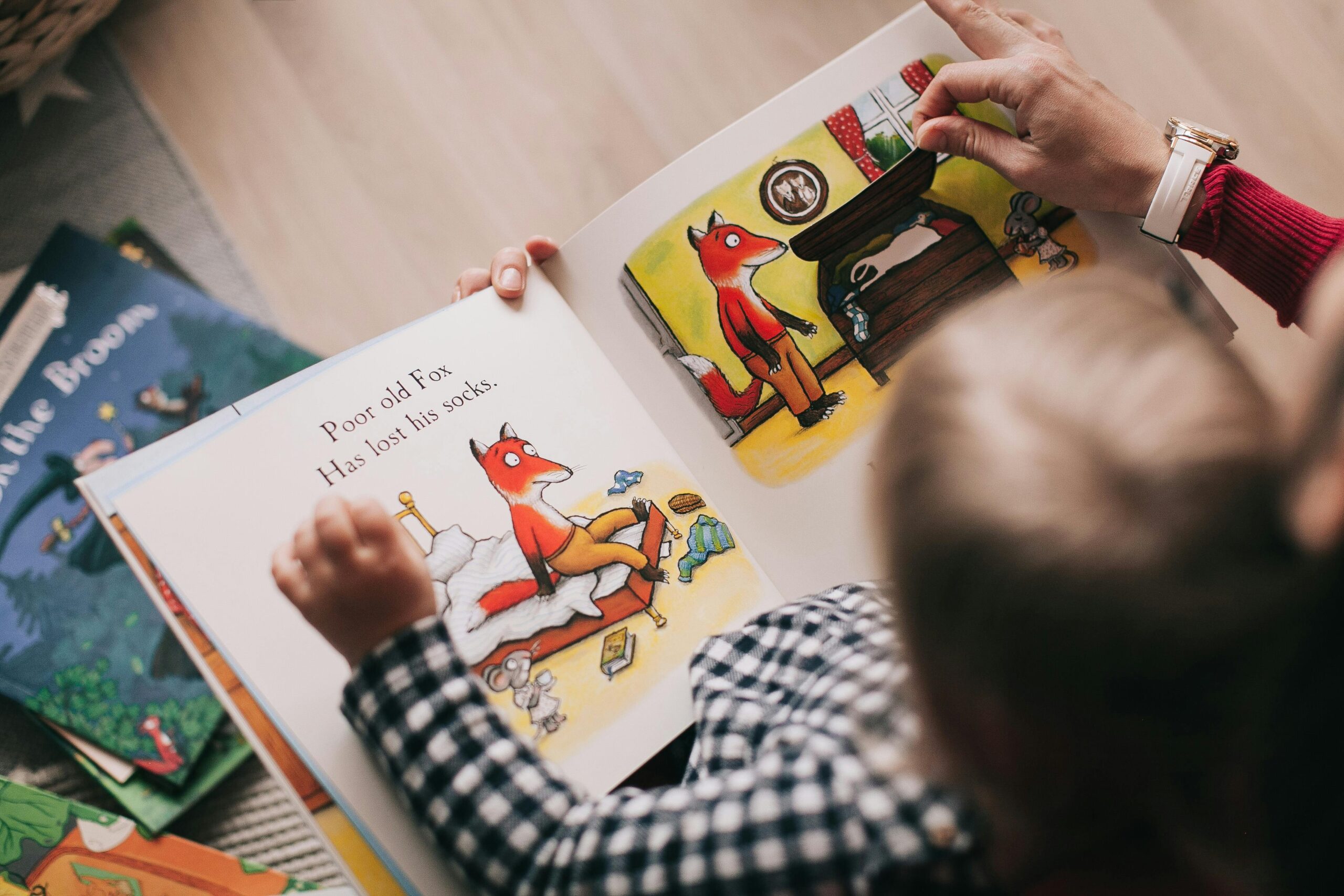 view from the top of the head of a toddler reading a story book